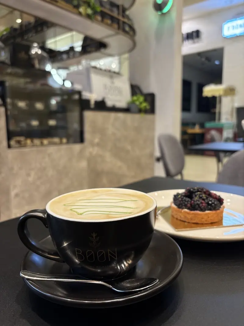 A Boon cappuccino with a berry tart