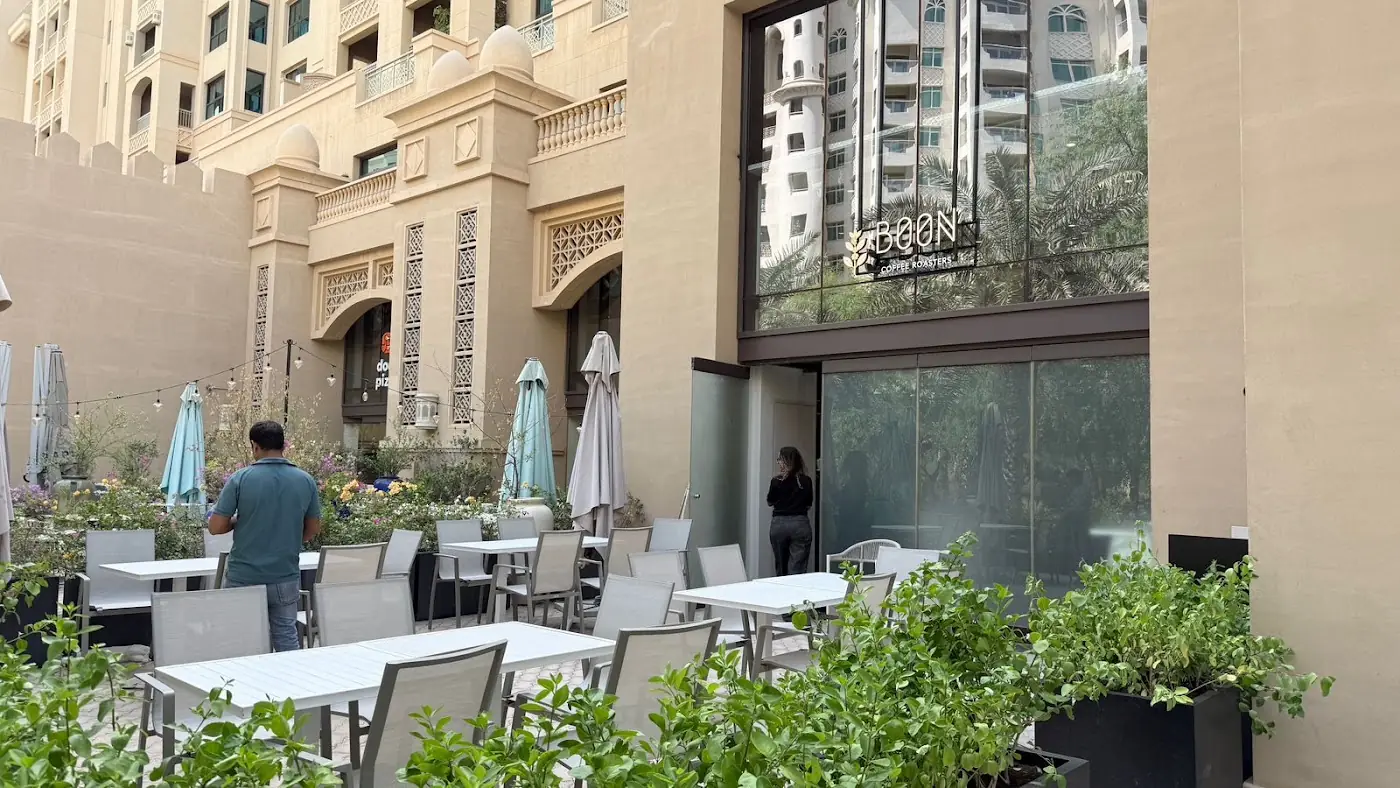 The Boon terrace with umbrellas and planters at Golden Mile 2